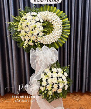 Kệ hoa chia buồn vòng lan trắng cao cấp, hoa cúc kem trang nghiêm, kệ hoa viếng thiết kế vòng nguyệt quế sang trọng, hoa tang lễ tông trắng xanh thanh nhã